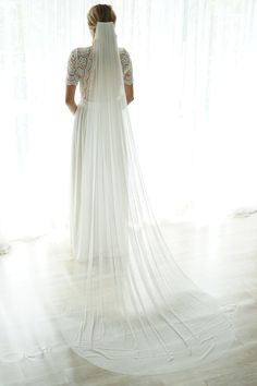 the back of a woman's wedding dress, with sheer white fabric on it