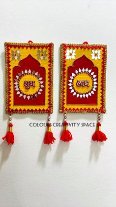 two red and yellow wall hangings with tassels