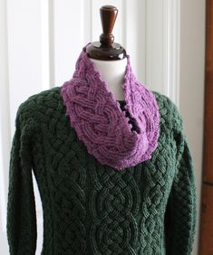 a green sweater with a purple scarf on it