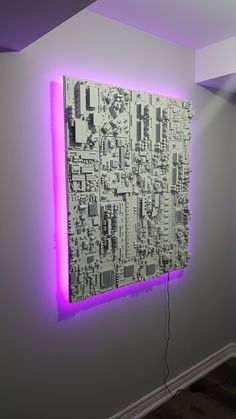 a purple light is shining on a wall with an electronic circuit board in the corner