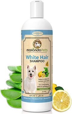 a bottle of white hair shampoo next to sliced lemons and leaves on a white background