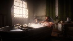 a man sitting in a bathtub with steam coming out of it