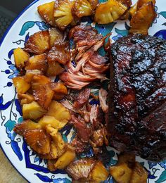 a plate with some meat and potatoes on it