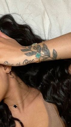 a woman laying on top of a bed with her arm wrapped around another woman's head