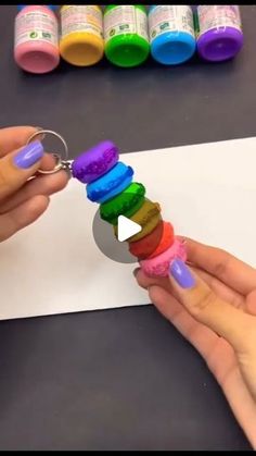 someone is making a rainbow keychain out of crayons