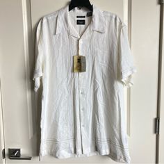 This Men’s Haggar Button Down Shirt Is Made With Linen And Rayon And Is New With Tags, It Has These Beautiful Embroidery Accents. There Is A Small Faint Spot In The Last Photo But I Think It Could Be Easily Washed Out. Otherwise Great Condition Leave A Comment If You Have Any Questions White Camp Shirt With Button Closure For Summer, White Shirt With Button Closure For Vacation, White Button-closure Shirt For Vacation, Classic Fitted Shirt For Vacation, Classic Fitted Vacation Shirt, White Camp Shirt With Spread Collar And Button Closure, White Camp Shirt With Button Closure And Relaxed Fit, White Camp Shirt With Spread Collar, White Camp Collar Shirt With Buttons