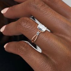 a woman's hand with an engagement ring on it