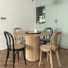 a dining table with four chairs around it