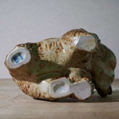 a ceramic object sitting on top of a wooden table