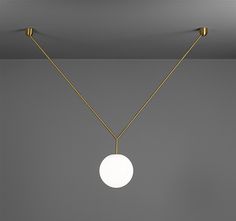 a white ball hanging from the ceiling with two lights attached to it's sides