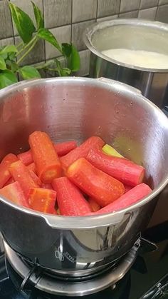 carrots are being cooked in a pot on the stove