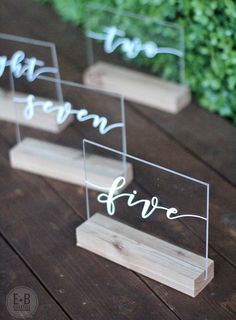 four clear acrylic signs with the words live, love and fire written on them