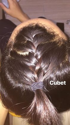 a woman's hair is braided into a bun with the words cubet on it