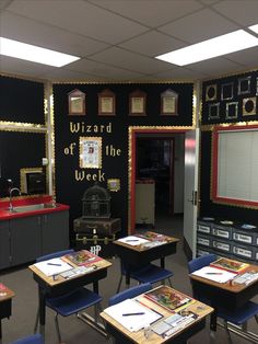 a classroom with desks and chairs in front of a chalkboard that says wizard of the week