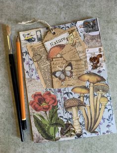 a piece of paper with mushrooms and butterflies on it, next to a marker pen