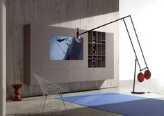 a living room with a television, chair and bookshelf on the wall next to it