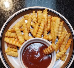 a plate with waffles and dipping sauce on it