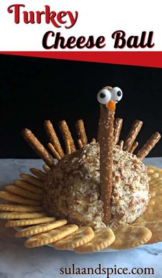 a turkey cheese ball with crackers and pretzels