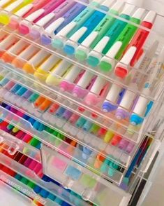 several plastic containers filled with different colored markers