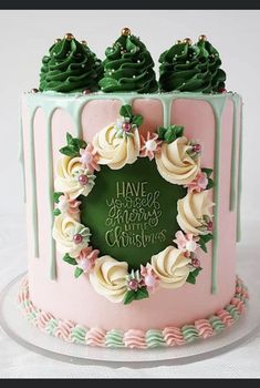 a pink and green cake with frosting on top