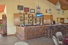 an empty bar with several chairs and pictures on the wall