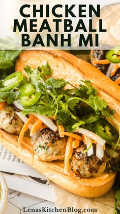 a chicken meatball banh mi sandwich with lettuce and carrots on it