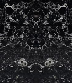 an abstract black and white marble pattern with some smaller circles in the center, on a dark background