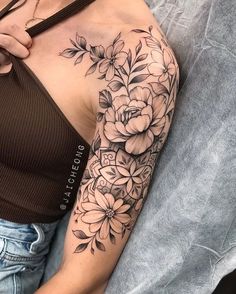 a woman with a flower tattoo on her arm