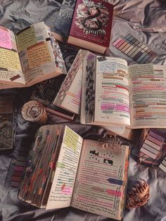 an open book sitting on top of a bed covered in lots of writing and papers