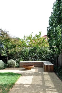 a wooden bench sitting in the middle of a garden