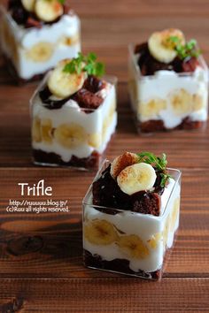 four desserts with banana slices and chocolate on top