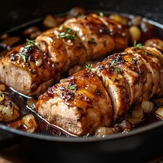 pork chops and onions cooking in a skillet