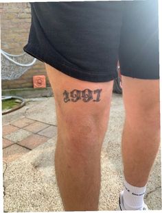 a man's legs with the word tiger written on them, in black ink