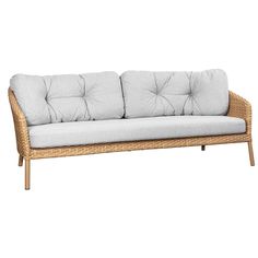 a wicker couch with white cushions on the top and bottom, in front of a white background