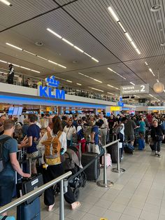 many people are waiting for their luggage at the airport