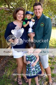 the family is posing for a photo with their trophy