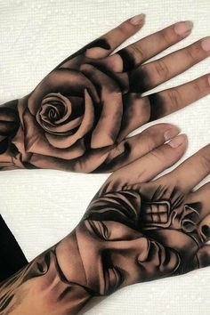 two hands that have tattoos on them and one has a rose tattooed on the palm