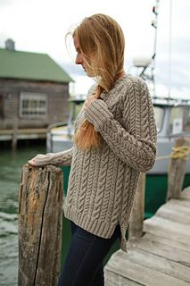 a woman standing on a dock next to the water