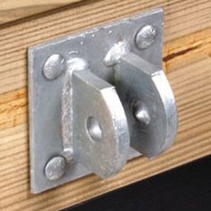 two metal latches on the side of a wooden door