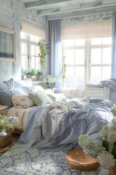 a bed sitting in a bedroom next to a window covered in blue and white sheets