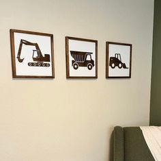 three framed pictures hang on the wall above a bed