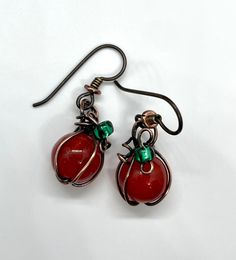 These charming mini pumpkin earrings feature beautifully crackled Agate beads in warm, autumnal tones, paired with copper accents to create a delightful pumpkin design. Topped with delicate green glass leaves, these earrings capture the essence of fall in a playful and elegant way. Finished with hypoallergenic niobium ear wires for comfort, these earrings are perfect for the season and ideal for anyone who loves whimsical, handcrafted jewelry. Niobium, which is naturally hypoallergenic, making t Copper Pumpkins, Copper Accents, Pumpkin Earrings, Mini Pumpkins, Pumpkin Design, Agate Beads, Ear Wire, Green Glass, Ear Wires