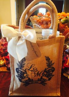 a bag with a bow on it sitting on a table next to some pumpkins