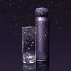 thermos bottle and tumbler are shown with stars in the sky