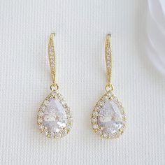 Teardrop Dangle Earrings in Silver Cubic Zirconia for Brides and Bridesmaids Glittery Emma teardrop dangle earrings are dainty and delicate for brides and bridesmaids. These teardrop dangle earrings for weddings are made of cubic zirconia in silver tone, which is rhodium plated and tarnish resistant. The teardrop CZ crystal drop is decorative with a central crystal and tiny CZ crystals surrounding them, making it highly reflective. These earrings dangle from cubic zirconia studded ear hooks with Simple Wedding Jewelry Sets, Rose Gold Bridesmaid Jewelry, Wedding Dangle Earrings, Rose Gold Jewelry Set, Wedding Jewelry Simple, Gold Bridesmaid Jewelry, Rose Gold Bridal Earrings, Bridal Earrings Drop, Gold Bridal Earrings