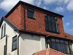 an image of a house that is made out of bricks and shingles on the roof