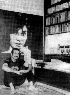 two people sitting on the floor in front of a book shelf with bookshelves