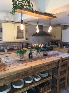 a large kitchen island with pots and pans on the counter top in front of it