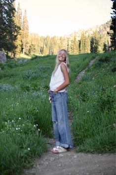 a woman standing in the middle of a field