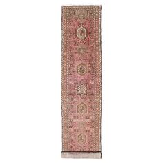 an antique persian runner rug with pink and beige colors, on a white background in the middle